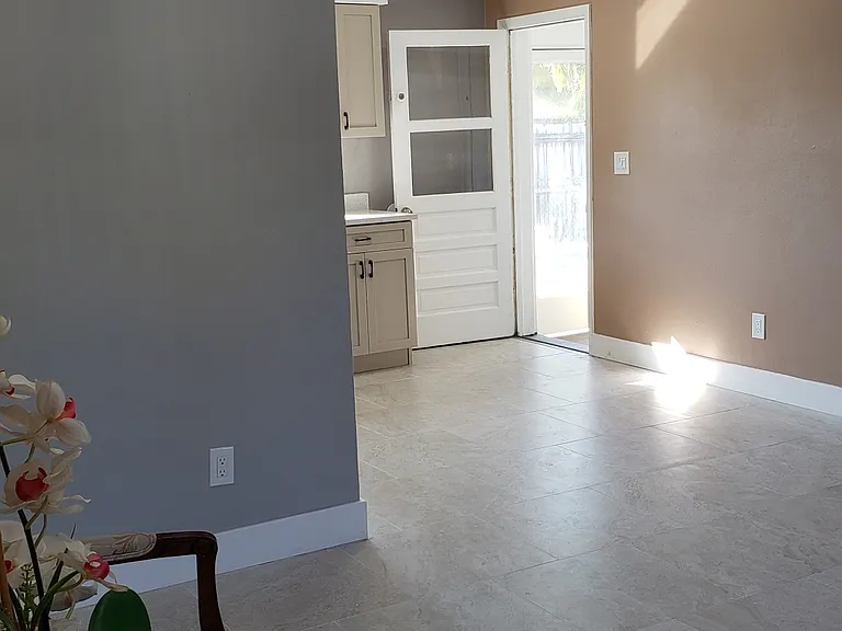 Looking from Living Room area towards Dining Area and Back Door to Back Yard, Laundry Room, and Storage Room.
