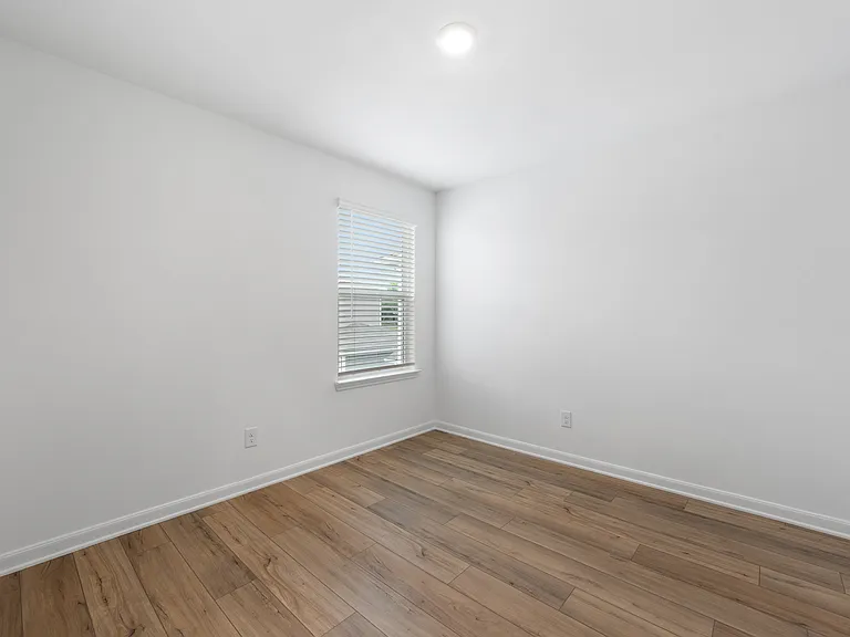 An additional bedroom with vinyl flooring.