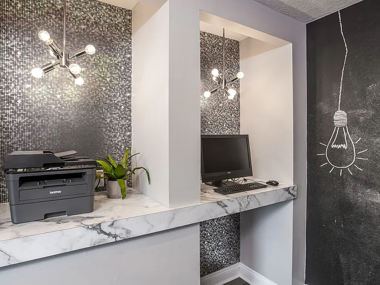Whether you're printing documents or checking emails, the fully equipped business center at Harper Grand Apartments supports your remote work needs in style.