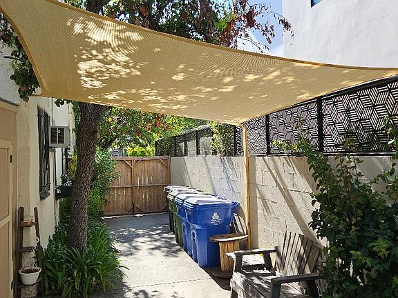 View from front door; sitting area and sun shade