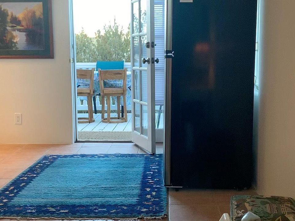 Outdoor living is one of the features of this property. It has the deck out the side yard overlooking the arroyo and a patio with bistro table out the front door. Traffic is quite low and not noisy and there is a front yard and vegetation providing privac