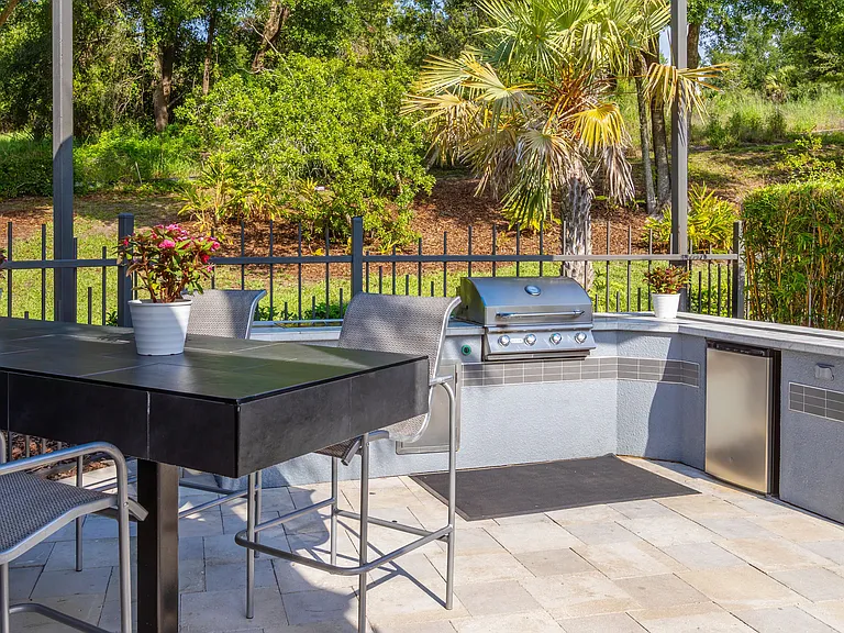Cook, entertain, and unwindthis sleek outdoor kitchen is your go-to spot for summer BBQs and casual poolside dining.