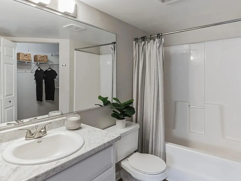 Revel in the luxurious primary bathroom oasis, featuring wood-style flooring and an oversized vanity.