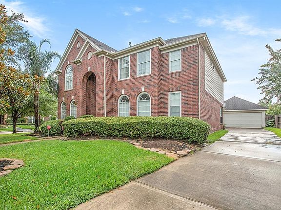 Long driveway with a 2-car detached garage and automatic garage door opener.