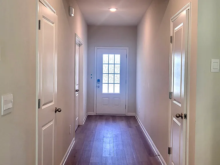 Entrance hallway with office on left closet to door, internet storage closet on the left, and an addition storage closet to the right