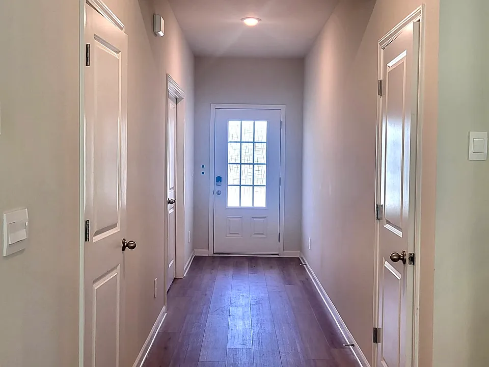 Entrance hallway with office on left closet to door, internet storage closet on the left, and an addition storage closet to the right