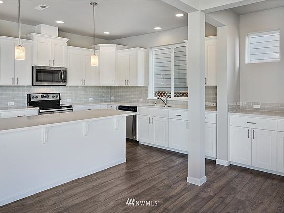 Microwave has been replaced with range hood; Stove is now gas instead of electric