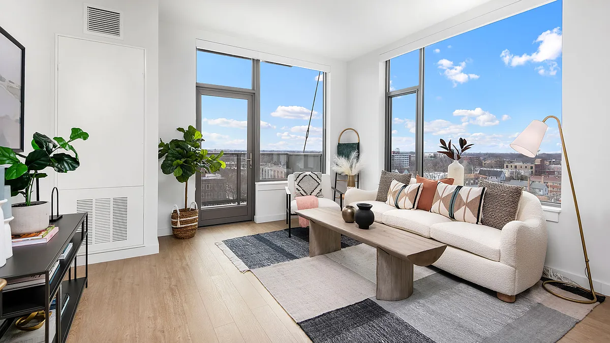Floor-to-ceiling windows and a private balcony bring Oak Park's skyline right into your living room at Eleven33 a bright, modern retreat made for unwinding. - Eleven33