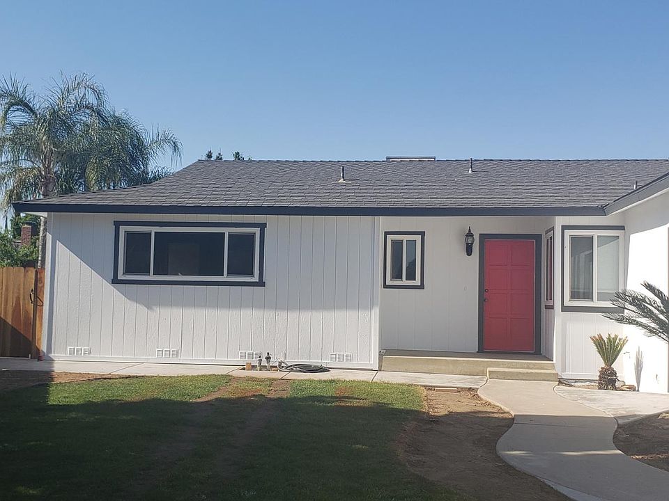 Side gate entry to back yard and trash bin storage.