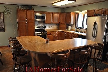 Kitchen - SS stove and microwave 1 year old, fridge 4 years old (25 cu-ft) bottom pullout freezer. Chairs included around island.