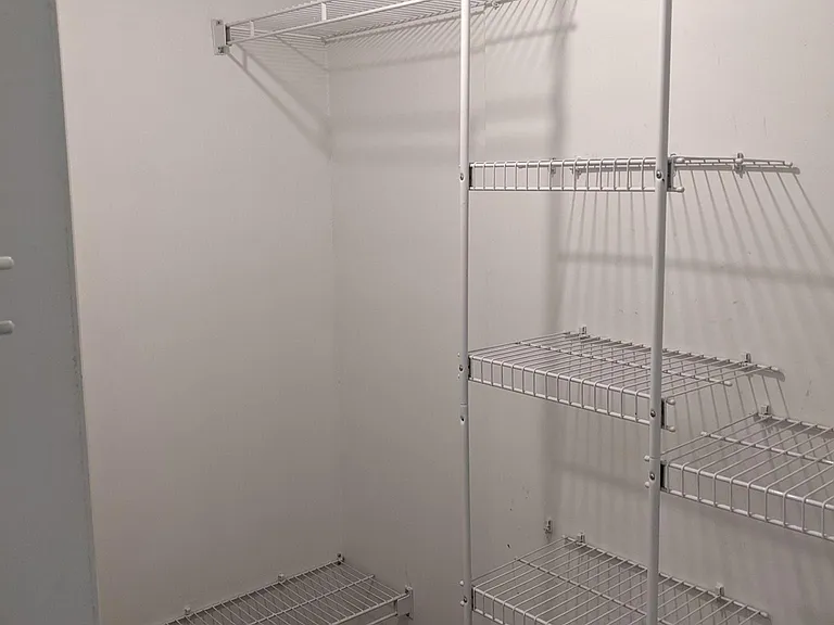 Rear of L-shaped walk-in closet.