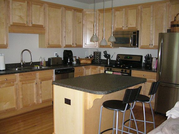 Spacious Kitchen with stainless steel appliances and wood floors.