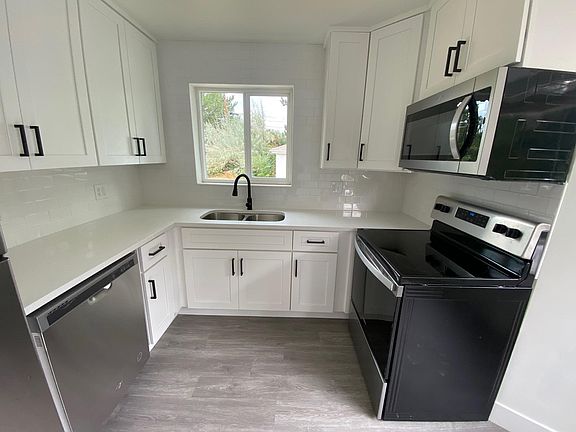 New quartz countertops, backsplash and hardware throughout the kitchen