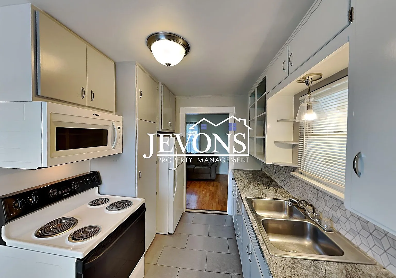 A 2-bedroom home with a 2-car garage plus driveway parking, and an in-unit washer and dryer — Photo 2