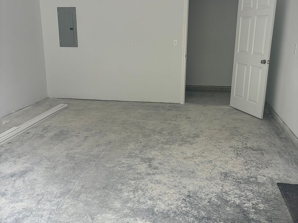 View of the garage bay / electric panel and storage area.