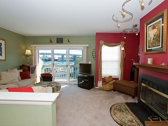 Living Room With Sliders To Balcony Overlooking The Marina