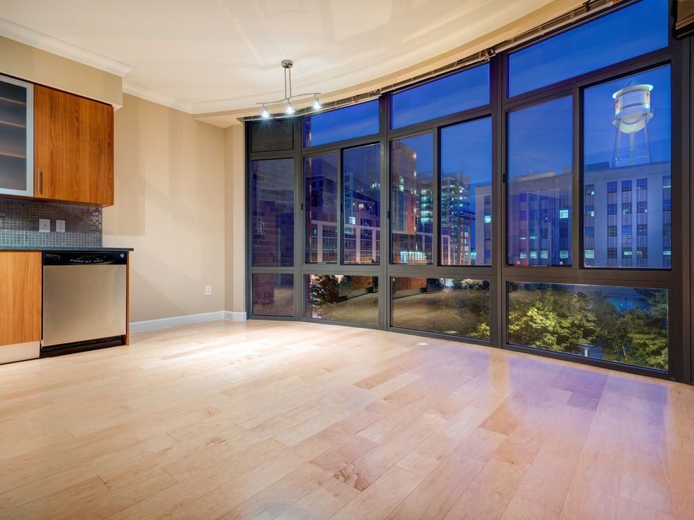 Kitchen with granite countertop, stainless steel appliances, designer backsplash, hard surface flooring and floor to ceiling windows