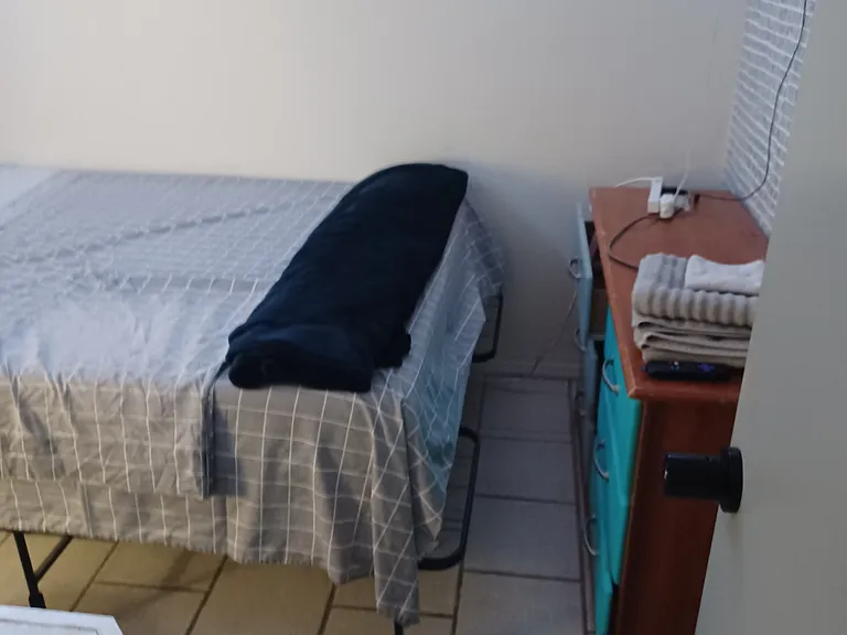 Wall mounted smart TV with dresser and bed Room 2