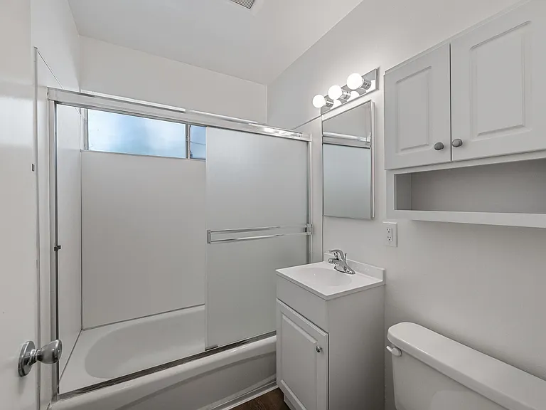 A typical bathroom, featuring a window above the shower to provide light an fresh air if desired.