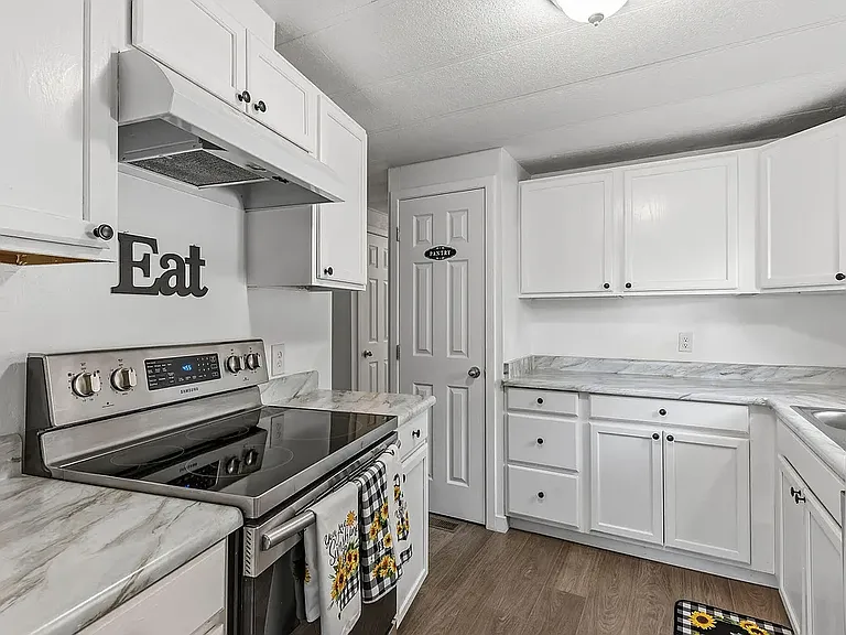 Glass top stove with pan storage in bottom drawer. Large Pantry. Freshly painted. This kitchen feels like home.