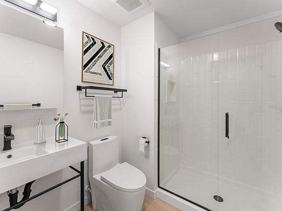 Step into a sleek bathroom retreat where simplicity and elegance meet.