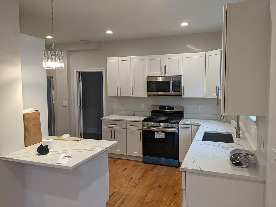 View of kitchen from living room. Door leads to bedroom.