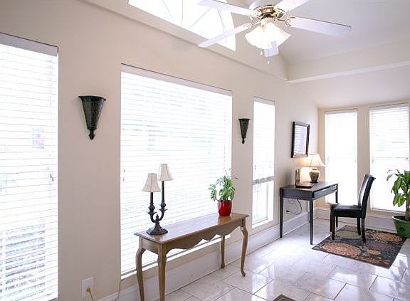 View of the sun room and home office, notice how much natural light fills this