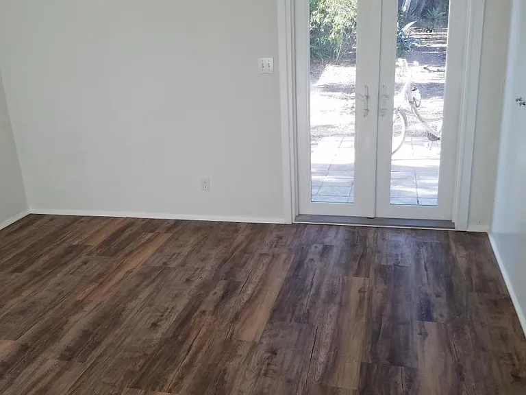 Master bedroom with view of backyard