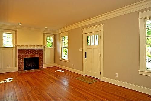 Living Room with brick fireplace and built-in bookshelves.