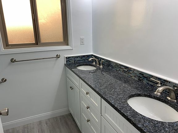Master en suite bath with beautiful blue granite dual sinks and tons of storage in the soft close cabinets. Light and bright with opening window for air flow.