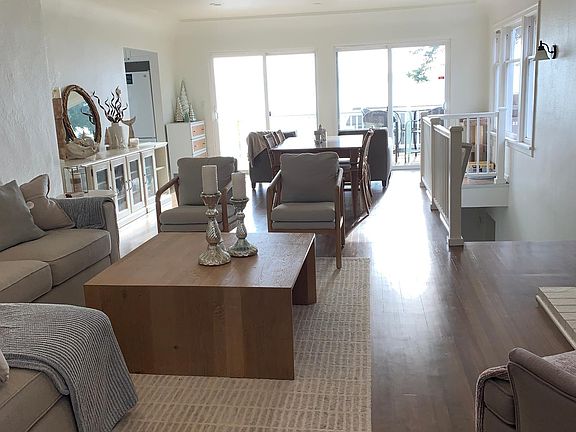Open concept living room looking towards view deck