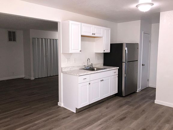 Kitchen with stainless steel appliances and marble formica countertops.
