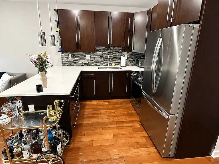 Modern kitchen with stainless steel appliances and quartz countertops