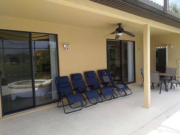 The covered part of the lanai offers access to the second bathroom (with the open door in the picture), master bedroom on the left, living room, and garden.