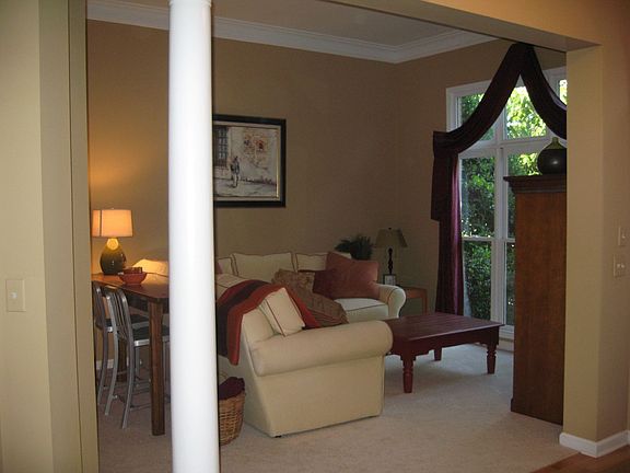 Formal Living Room with Floor to Ceiling Windows and Crown Molding