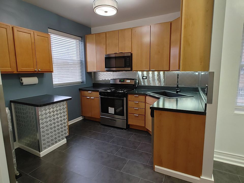 Kitchen with never-used new SS appliances. New cabinets. New flooring. New Paint.