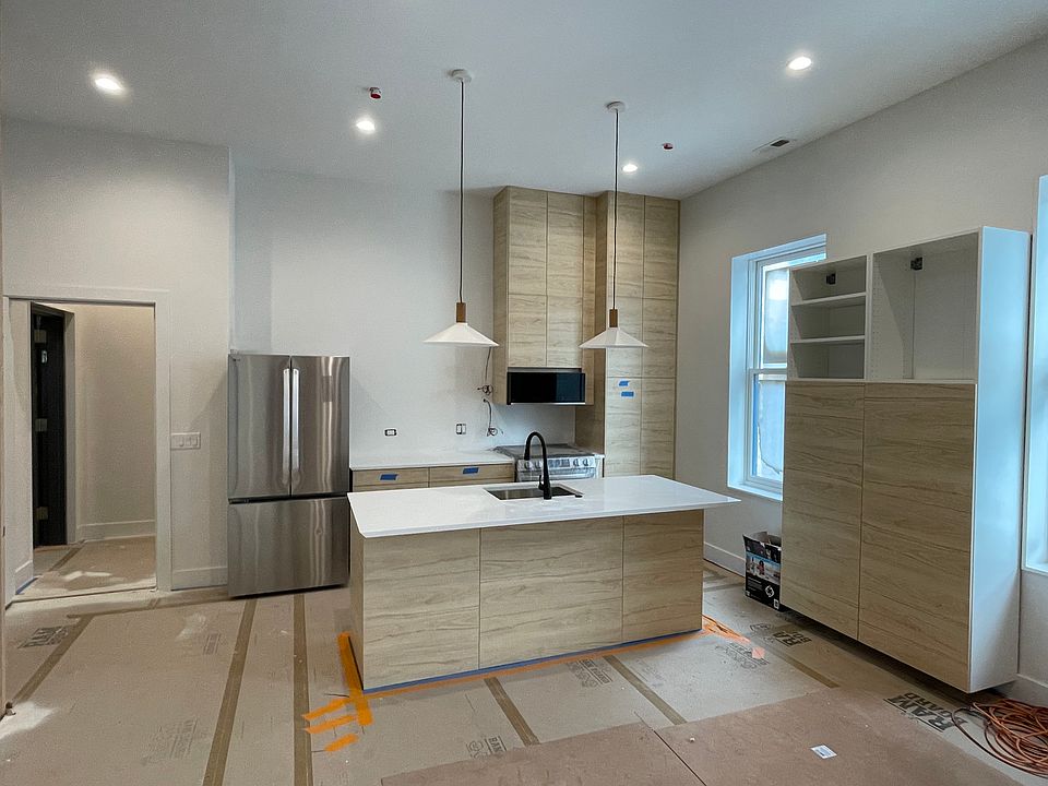 In-progress photo of kitchen - will have reclaimed wooden shelves with under shelf lighting.