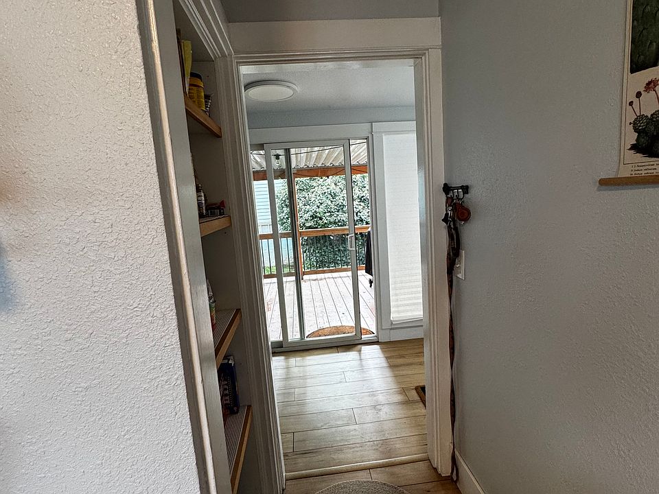 Kitchen pantry hall to washroom and back slider to covered deck.