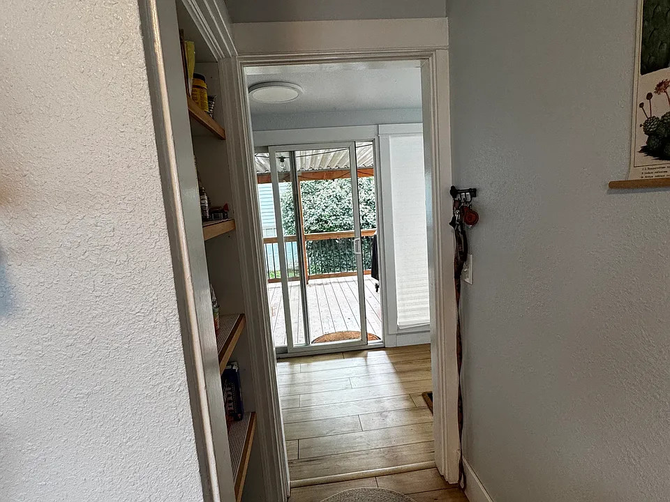 Kitchen pantry hall to washroom and back slider to covered deck.