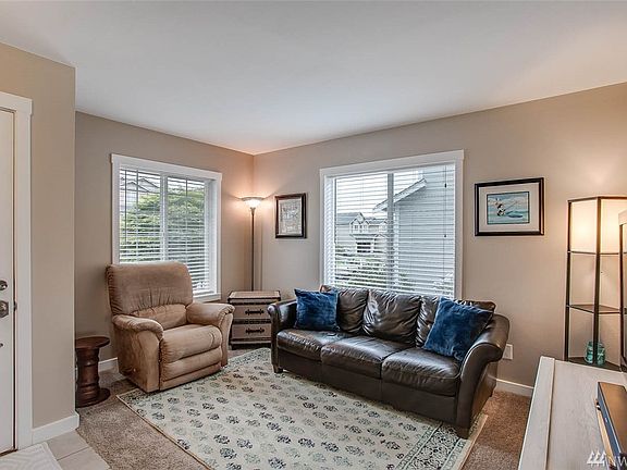 This cozy living room is loaded with light from the two large front windows.