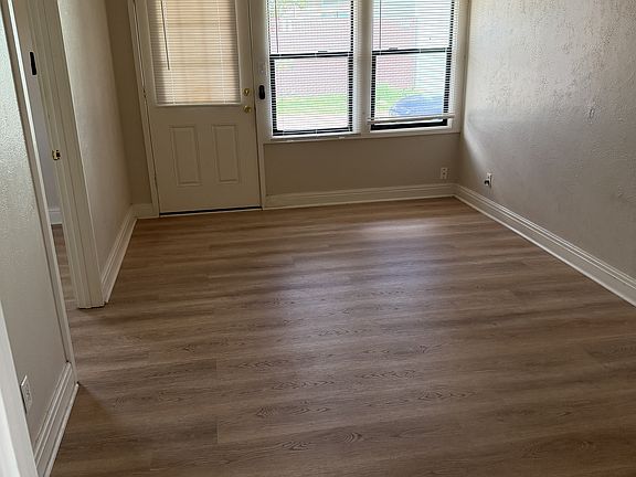 living room with minisplit, fan, luxury vinyl plank flooring