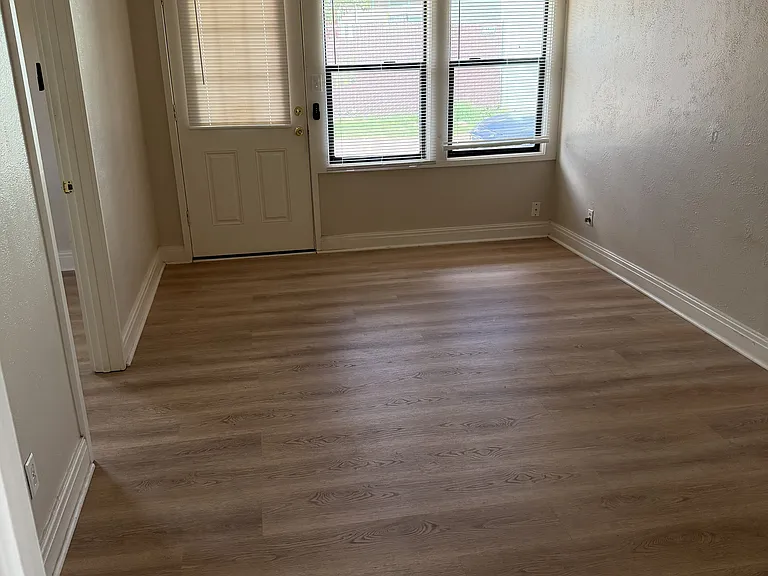 living room with minisplit, fan, luxury vinyl plank flooring