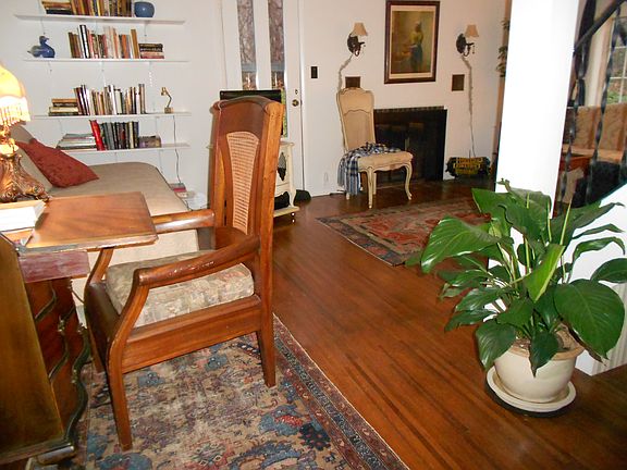Living room has desk & bookshelves