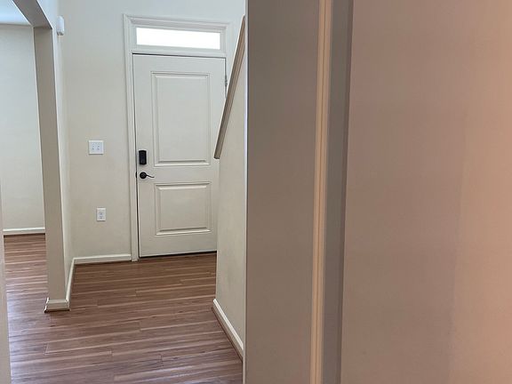 Main hall leading to the kitchen and downstairs half bath.