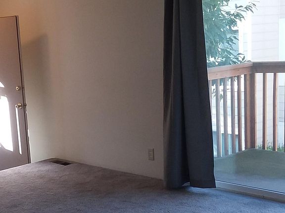 sunny, large living room with balcony