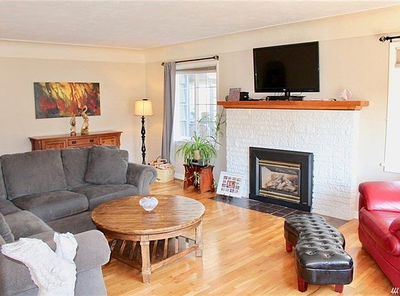 Ample living room with beautiful hardwood floors,gas fireplace, coiffured ceilings and lots of windows for plenty of light.