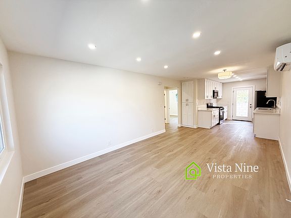 Spacious living room and dining room space with plenty of light - windows and recessed lighting Hardwood-like Luxury Vinyl Plank throughout the home.