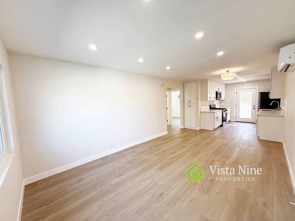 Spacious living room and dining room space with plenty of light - windows and recessed lighting Hardwood-like Luxury Vinyl Plank throughout the home.