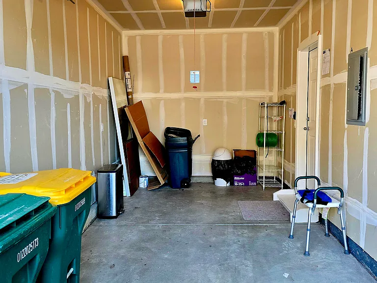 Attached on car garage with enough space in front for deep freezer or storage. If its too snug for your comfort, the driveway is always an option. There is ample free parking a few feet away as well.