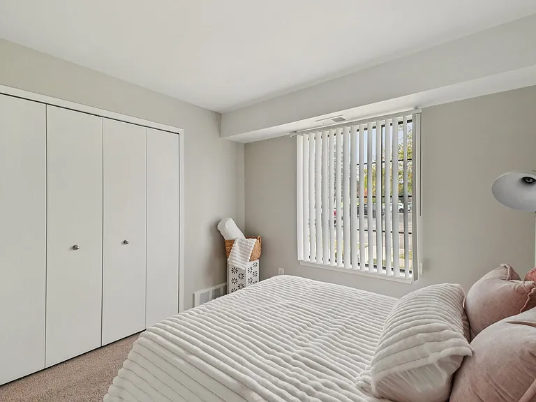 Relax in comfortable bedrooms featuring window blinds for privacy and light control, professionally operated by Highlands Vista Group.